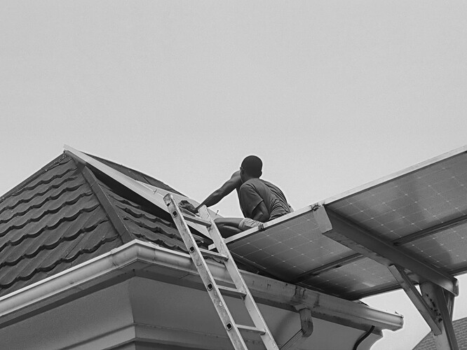 Co-workers on the roof mounting extra panels. Using Monochrome mode